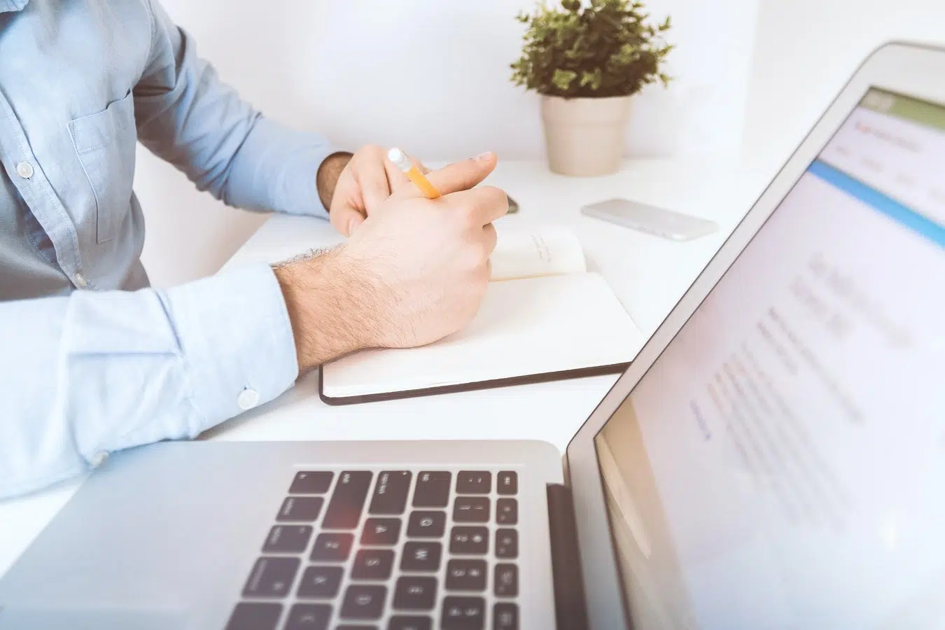 B2B market research companies researcher with laptop and notepad in an office