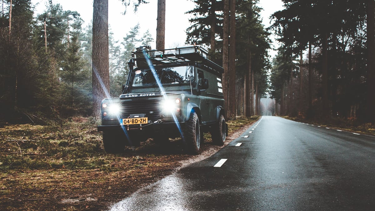 Land Rover in a forest to illustrate Mackman Research's work with Land Rover Monthly