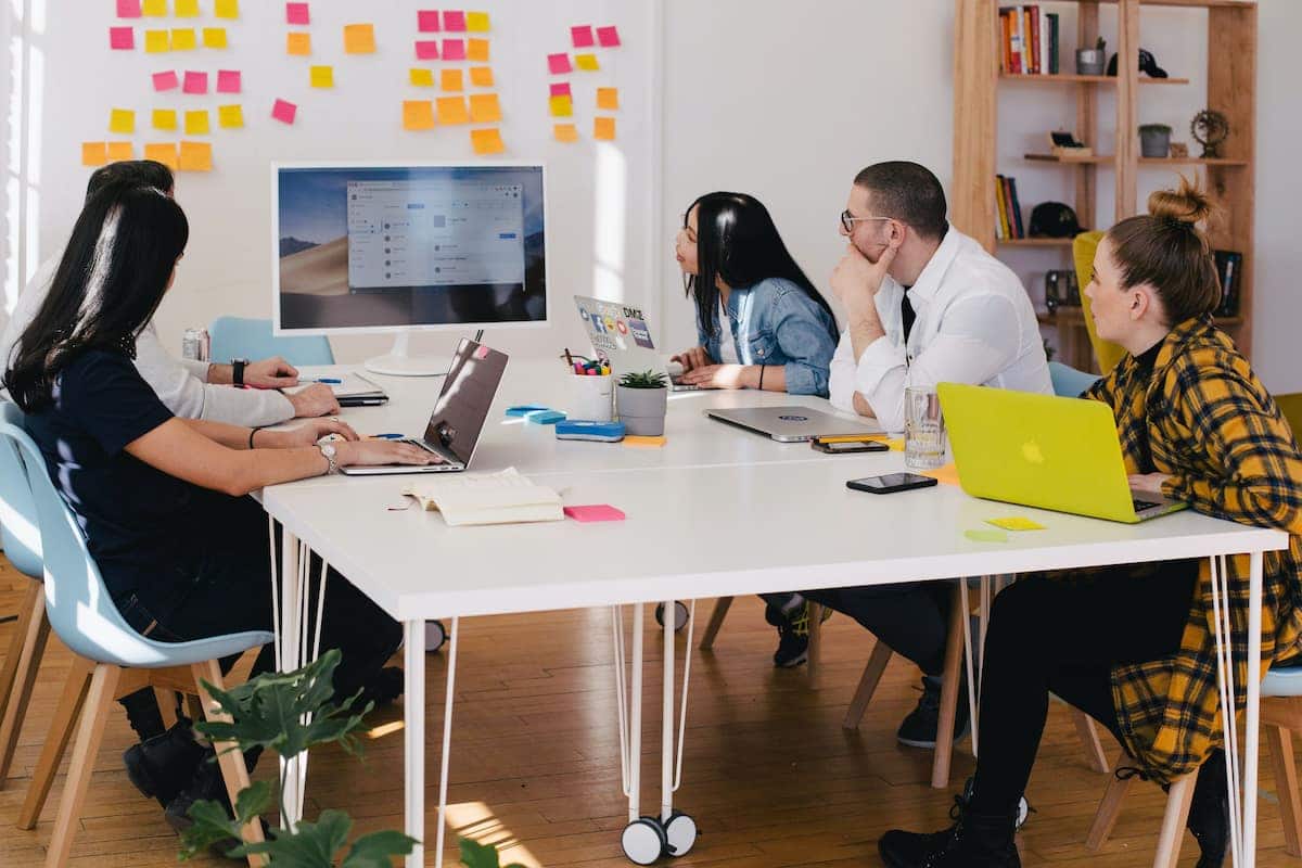 Team of 5 people working at a table