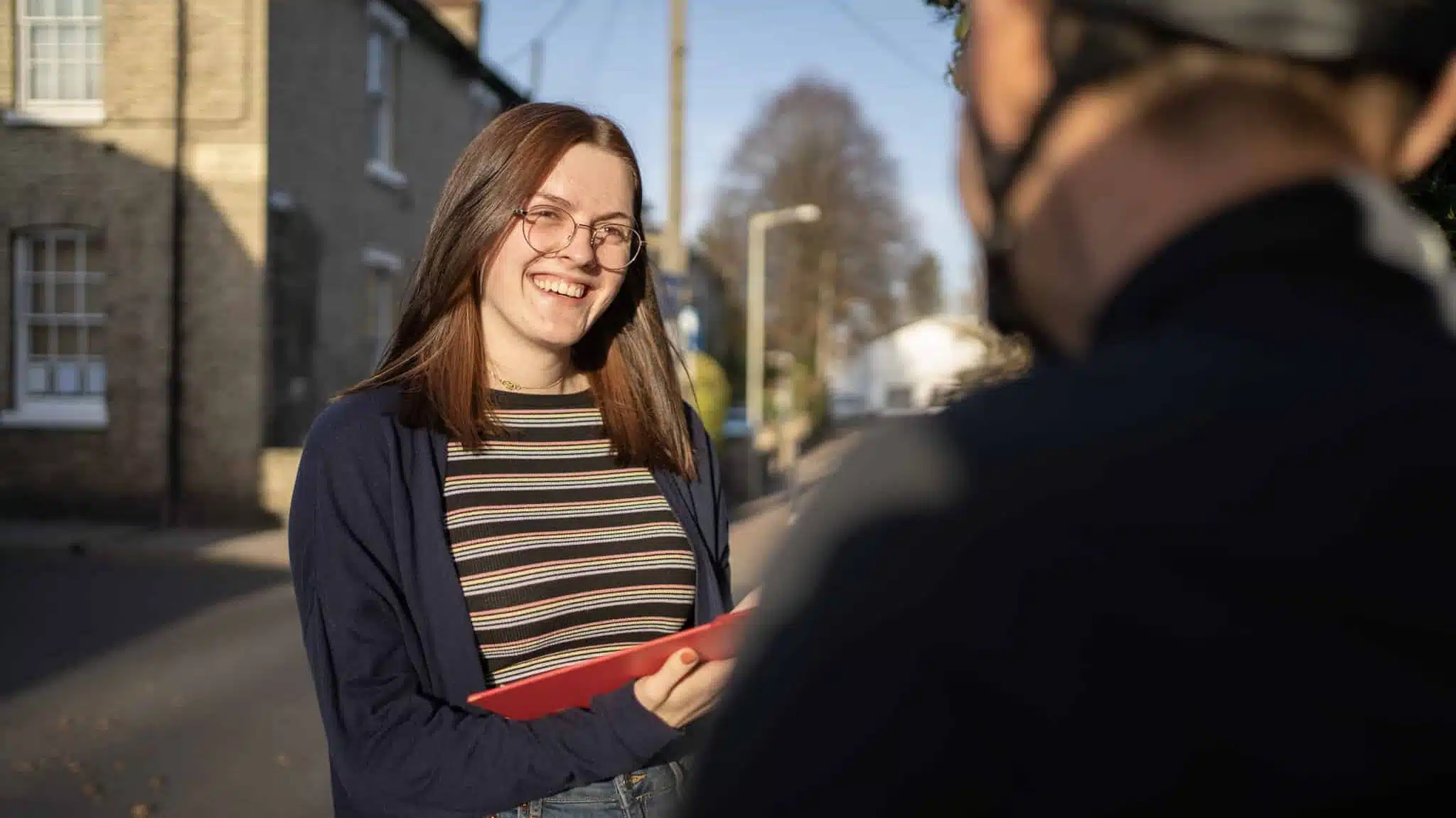 Photo of a researcher interviewing a cyclist in the street | Customer-centric Research | Mackman Research